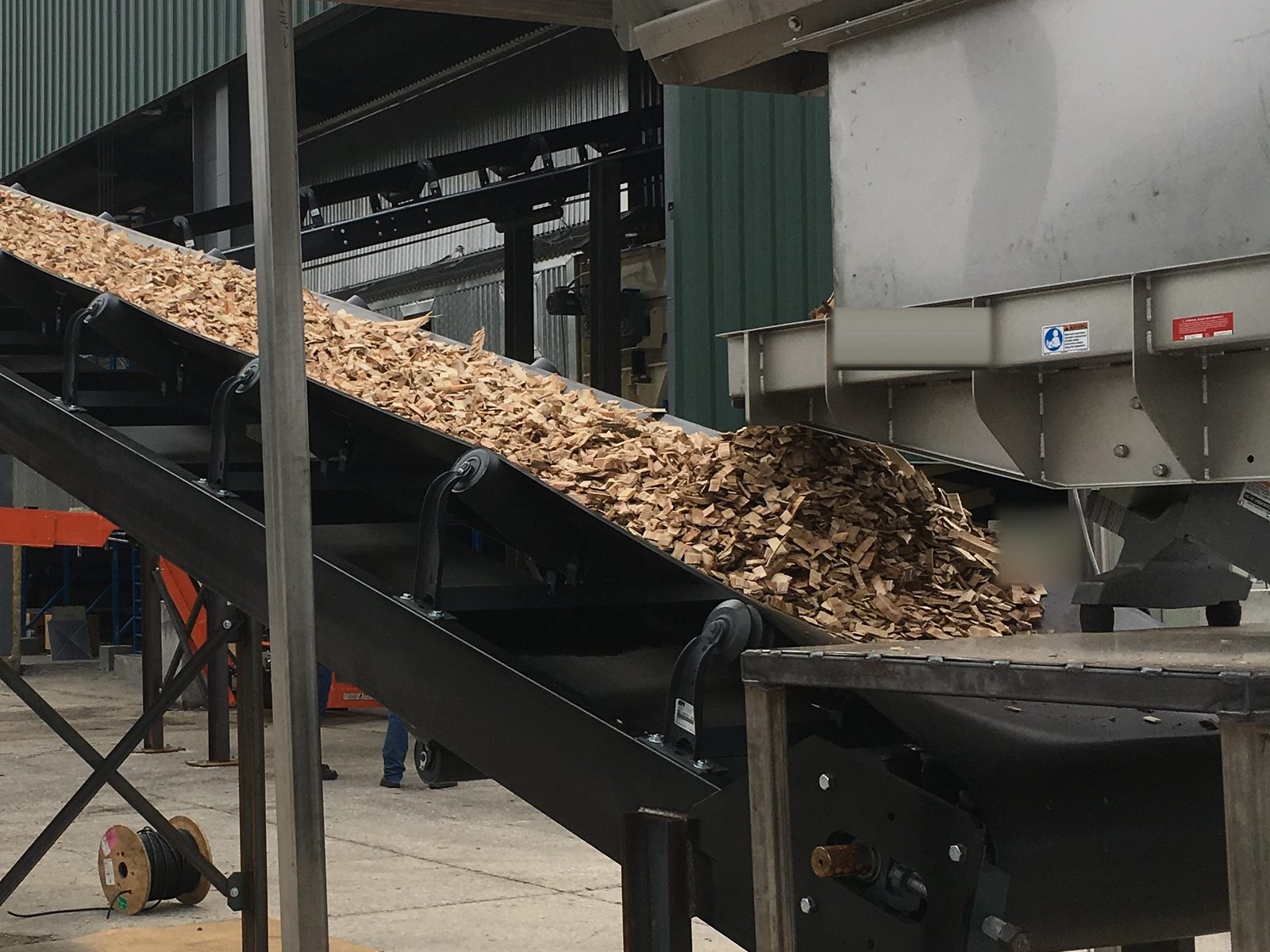 Wood chips on a feed conveyor